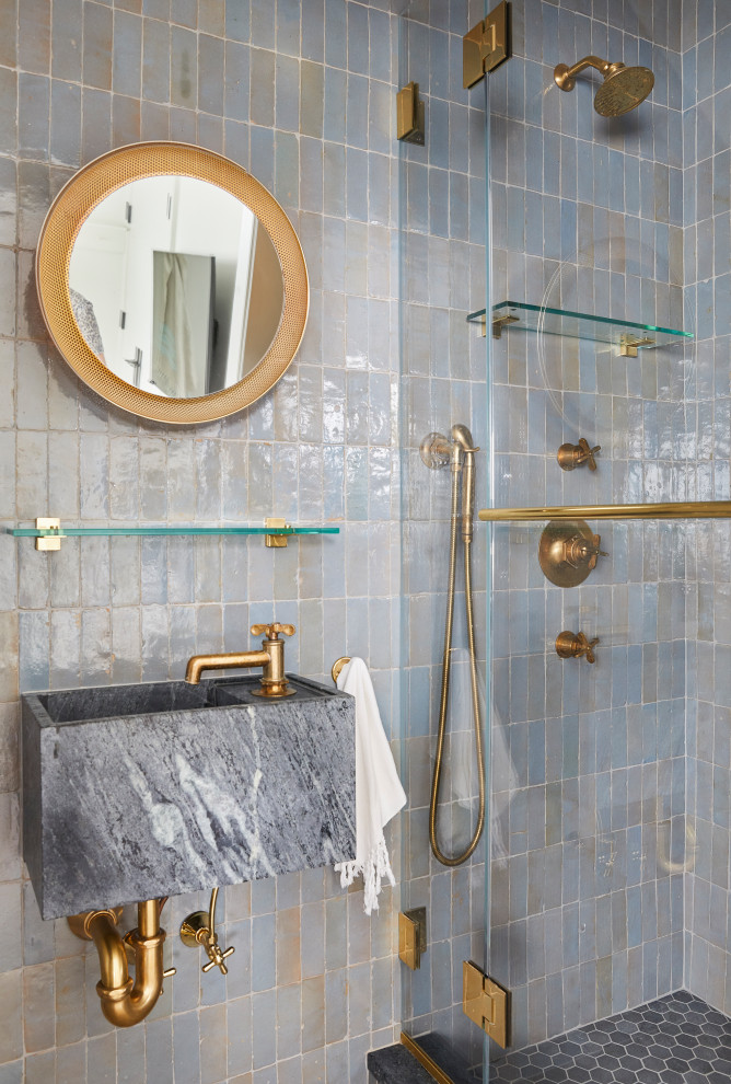 Inspiration for a beach style bathroom in New York with blue tiles, blue walls, a wall-mounted sink and a hinged door.