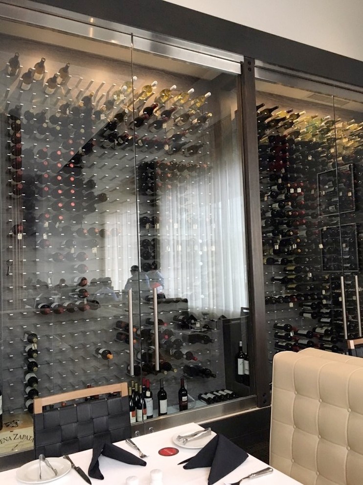 Photo of an expansive modern wine cellar in Chicago with display racks.