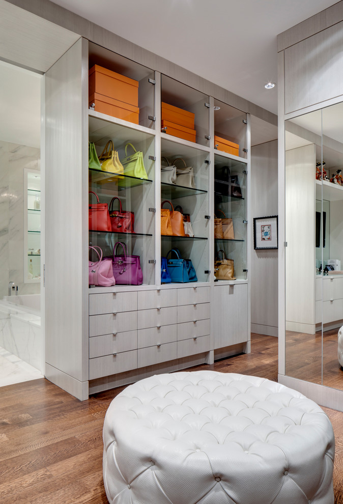 Design ideas for a contemporary walk-in wardrobe in Dallas with grey cabinets and medium hardwood floors.