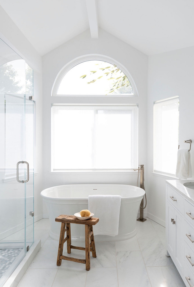 Design ideas for a medium sized traditional ensuite bathroom in San Francisco with a freestanding bath, a corner shower, a hinged door, a freestanding vanity unit, shaker cabinets, white cabinets, white walls, engineered stone worktops, white floors, white worktops, a feature wall, double sinks and exposed beams.