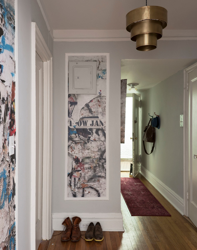 Inspiration for a mid-sized eclectic foyer in New York with grey walls and medium hardwood floors.