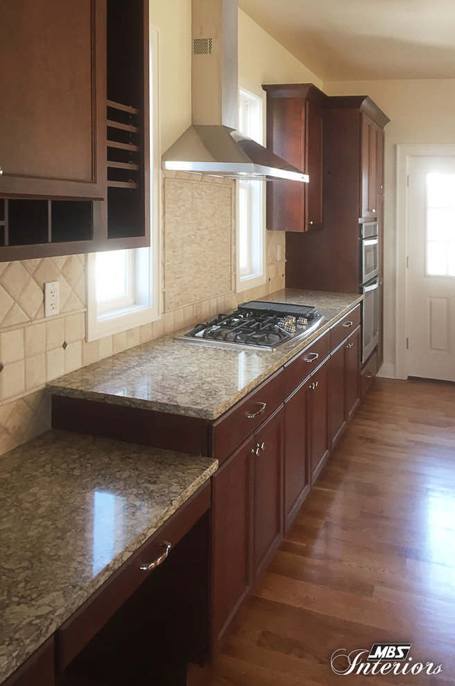 Eat-in kitchen - large transitional medium tone wood floor eat-in kitchen idea in Cincinnati with an undermount sink, recessed-panel cabinets, dark wood cabinets, quartz countertops, beige backsplash, stone tile backsplash, stainless steel appliances and an island