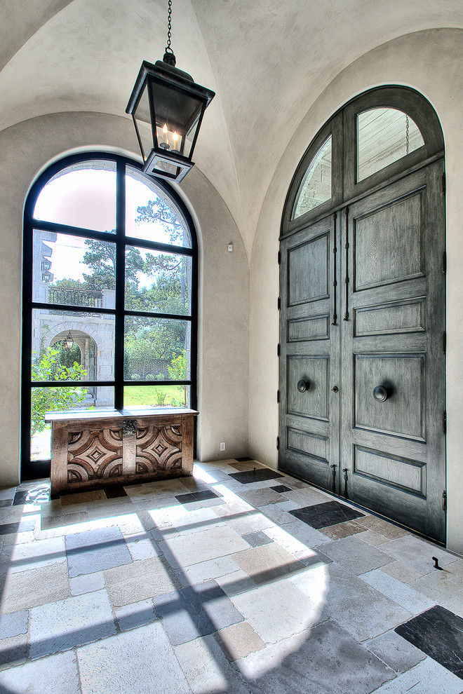 Photo of a large contemporary entryway in Houston with a double front door.