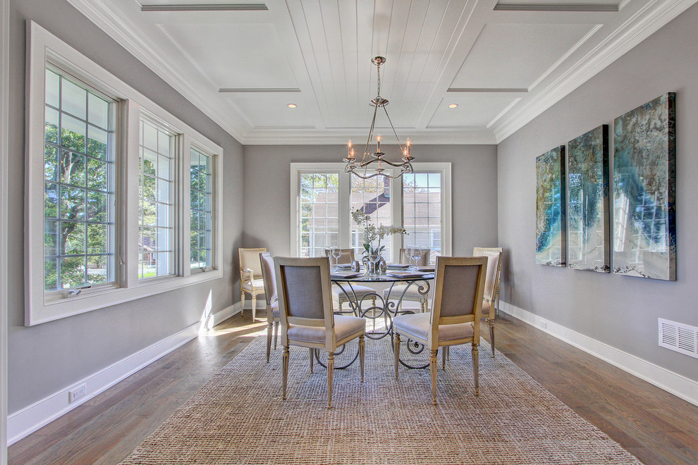 This is an example of a beach style separate dining room in New York with grey walls and light hardwood floors.
