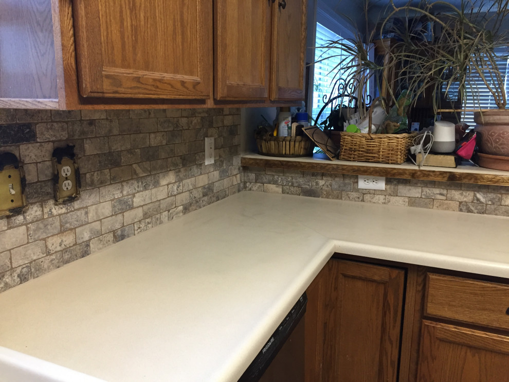 Inspiration for a mid-sized rustic eat-in kitchen remodel in Denver with stone tile backsplash