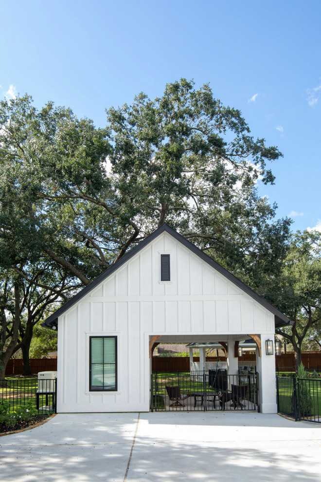 ヒューストンにあるラグジュアリーなカントリー風のおしゃれな家の外観 (コンクリート繊維板サイディング、混合材屋根、縦張り) の写真