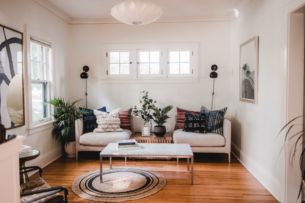 Example of a mid-sized transitional enclosed and formal light wood floor and brown floor living room design in Minneapolis with white walls, no tv and no fireplace