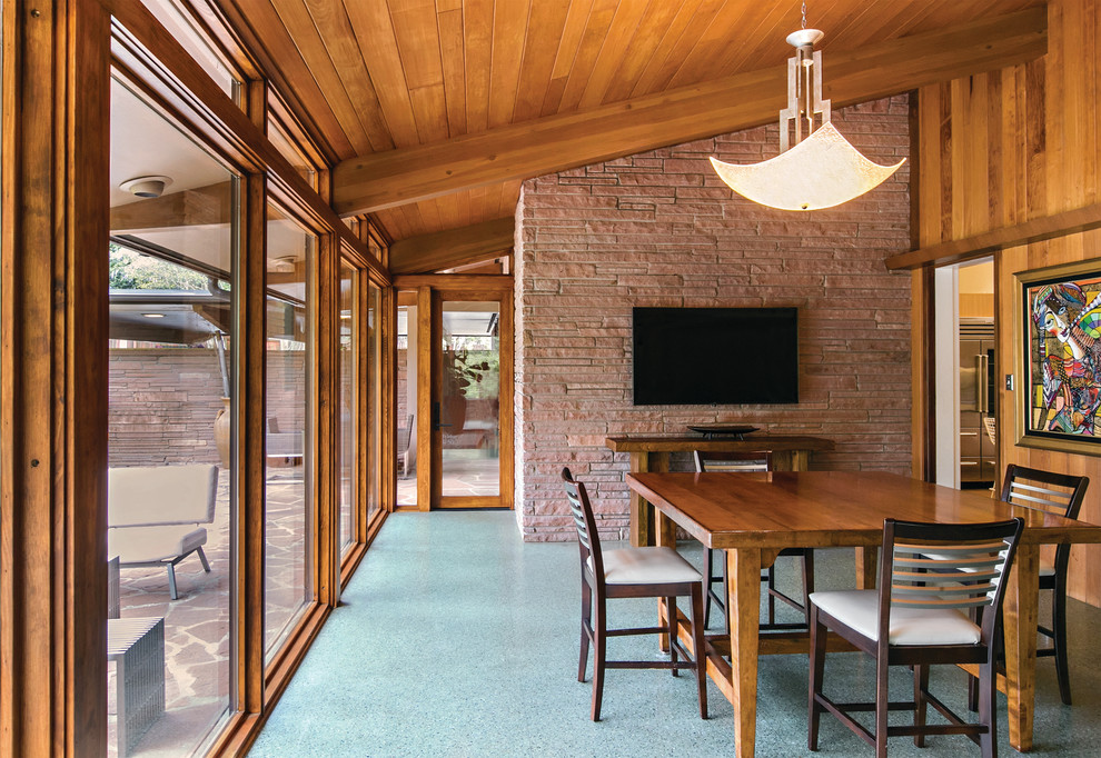 Large midcentury open plan dining in Portland Maine with brown walls, no fireplace and blue floor.