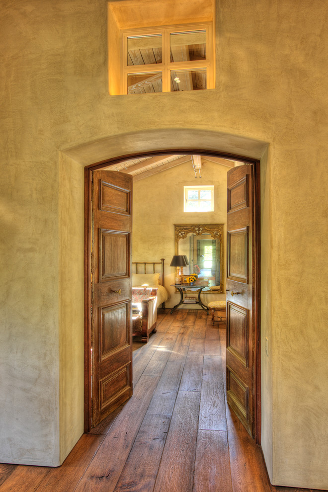 Photo of an eclectic bedroom in Sacramento with beige walls and medium hardwood floors.