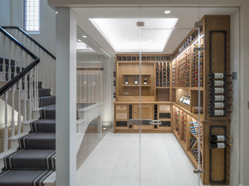 Photo of a contemporary wine cellar in London with display racks.