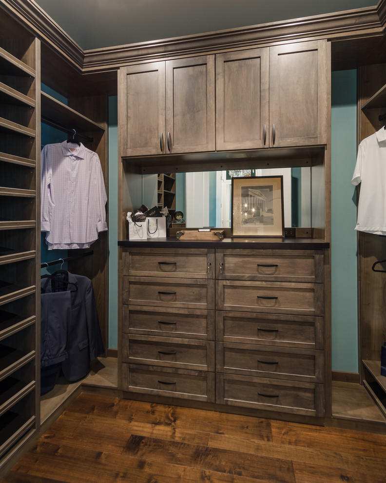 Small country men's walk-in wardrobe in Tampa with medium wood cabinets.