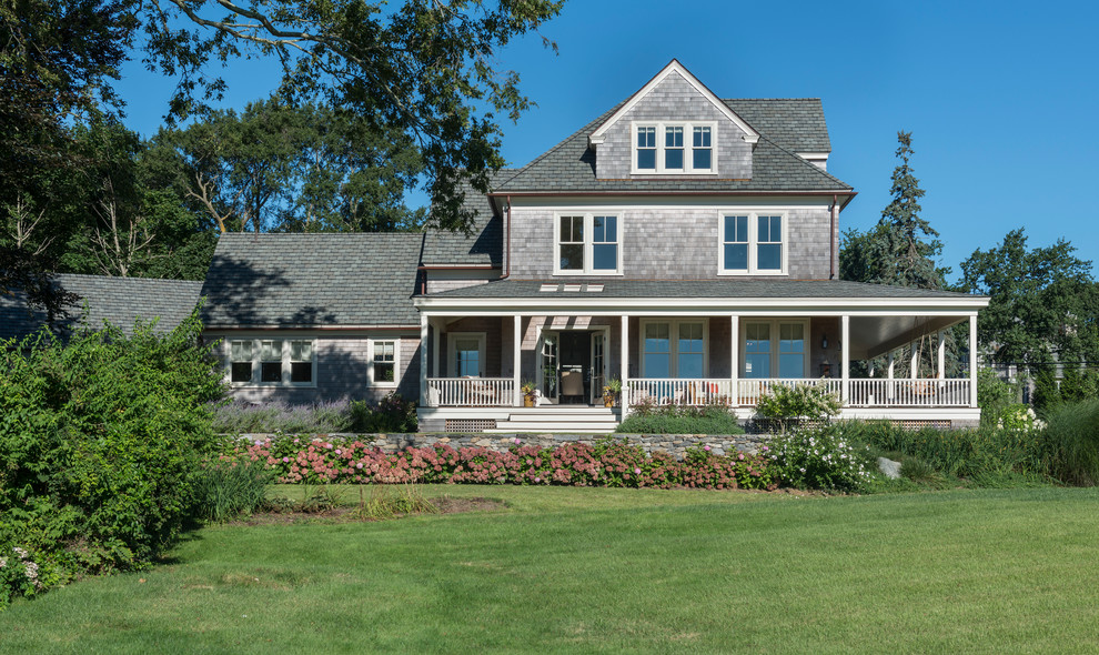 Inspiration for a beach style three-storey exterior in Providence with wood siding and a gable roof.
