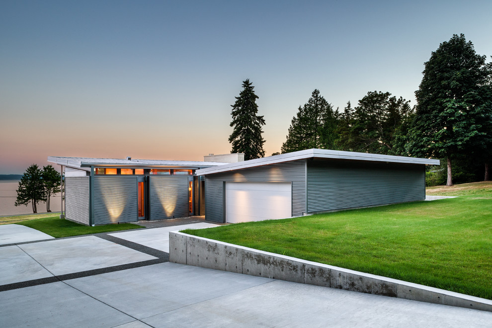 Inspiration for a small contemporary one-storey grey exterior in Seattle with metal siding and a shed roof.