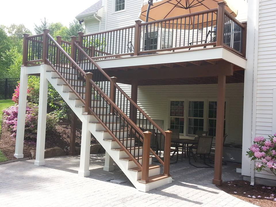 This is an example of a medium sized classic back first floor wood railing terrace in Boston with no cover.