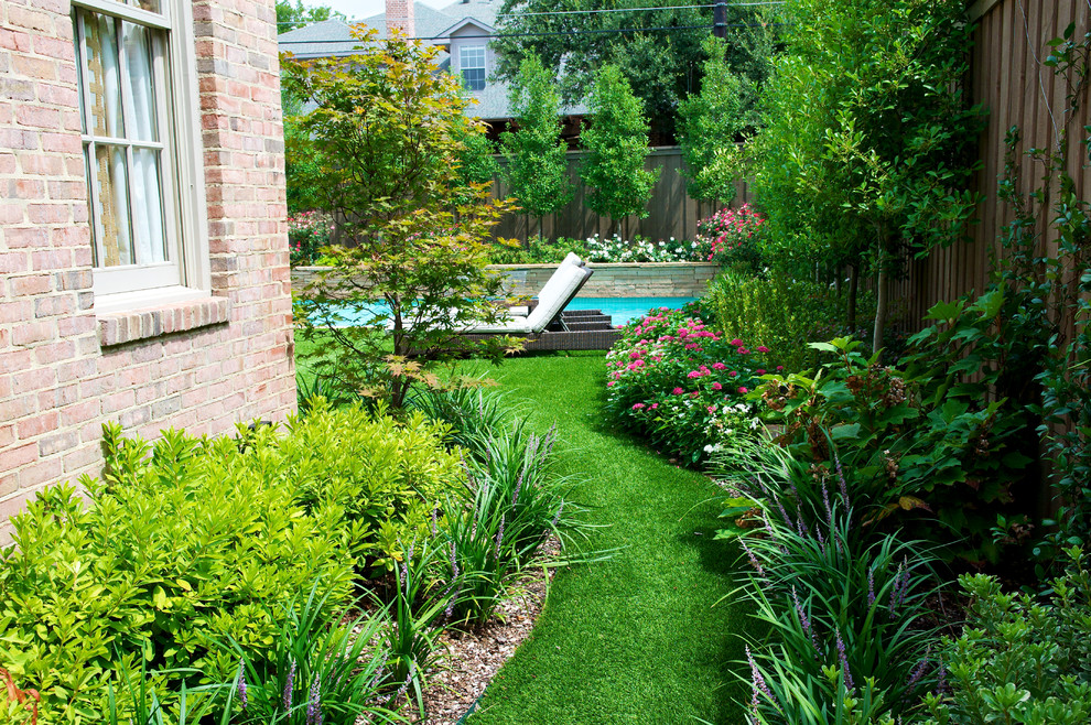 This is an example of a small transitional backyard rectangular pool in Dallas with natural stone pavers.