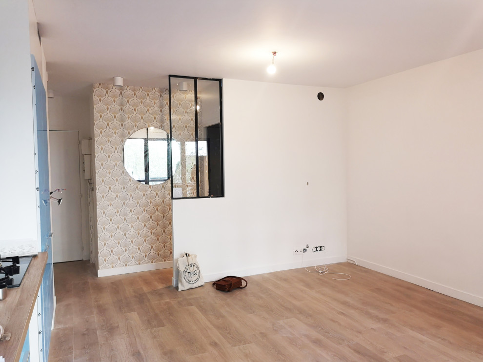 На фото: открытая гостиная комната среднего размера:: освещение в современном стиле с белыми стенами, полом из ламината, телевизором на стене, бежевым полом и обоями на стенах без камина