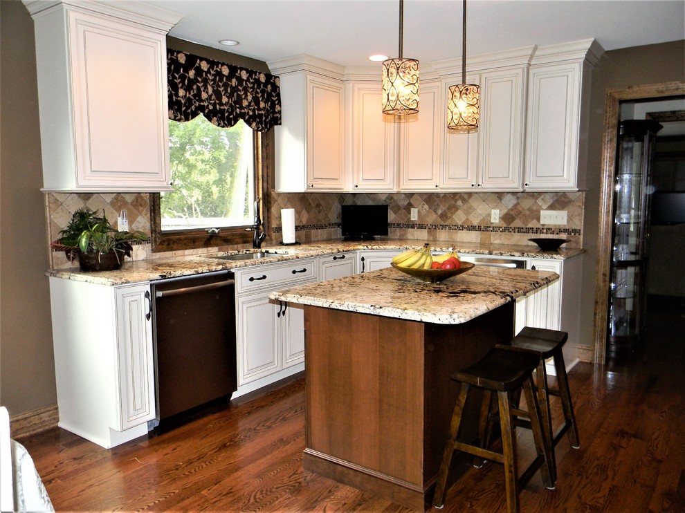 Large mountain style single-wall dark wood floor and brown floor eat-in kitchen photo in New York with an undermount sink, recessed-panel cabinets, white cabinets, granite countertops, beige backsplash, stone tile backsplash, stainless steel appliances and an island