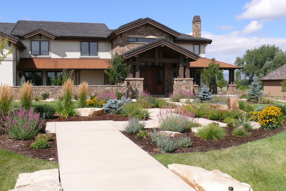 Inspiration for a traditional front yard driveway in Denver with concrete pavers.
