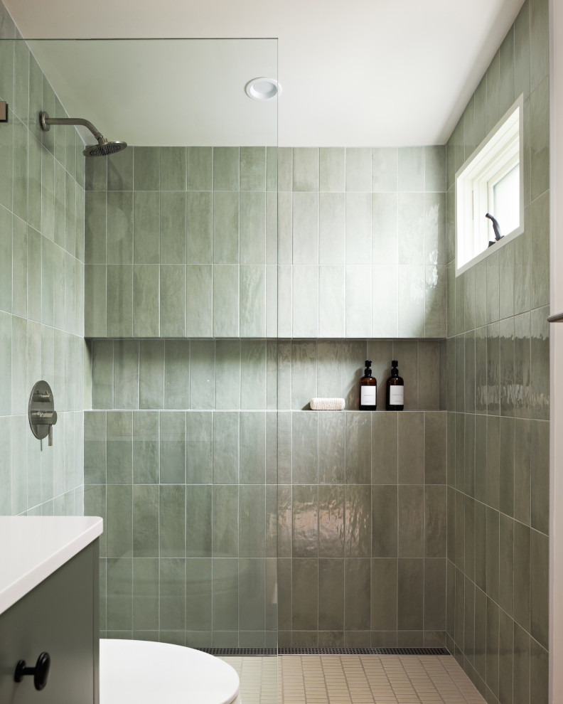 Inspiration for a contemporary green tile mosaic tile floor and beige floor bathroom remodel in San Francisco with flat-panel cabinets, green cabinets, green walls and white countertops