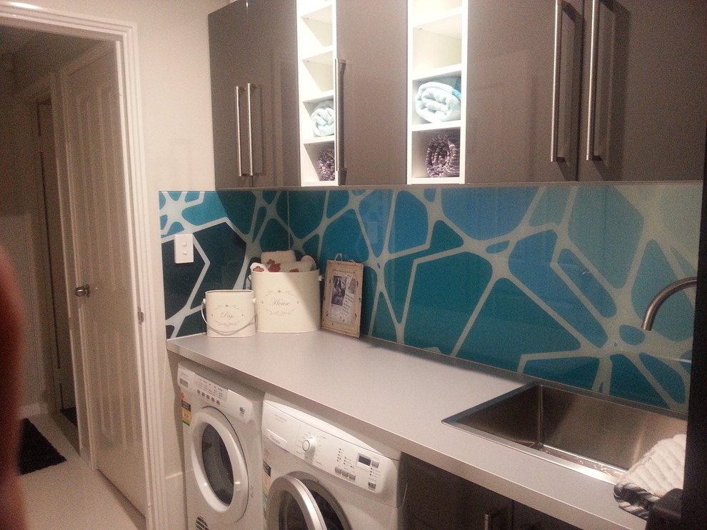 Small single-wall ceramic tile dedicated laundry room photo in Perth with a drop-in sink, flat-panel cabinets, brown cabinets, laminate countertops, gray walls and a side-by-side washer/dryer