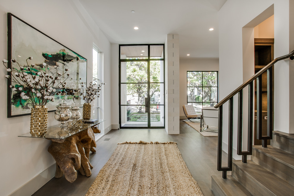 Inspiration for a transitional dark wood floor single front door remodel in Dallas with white walls and a glass front door