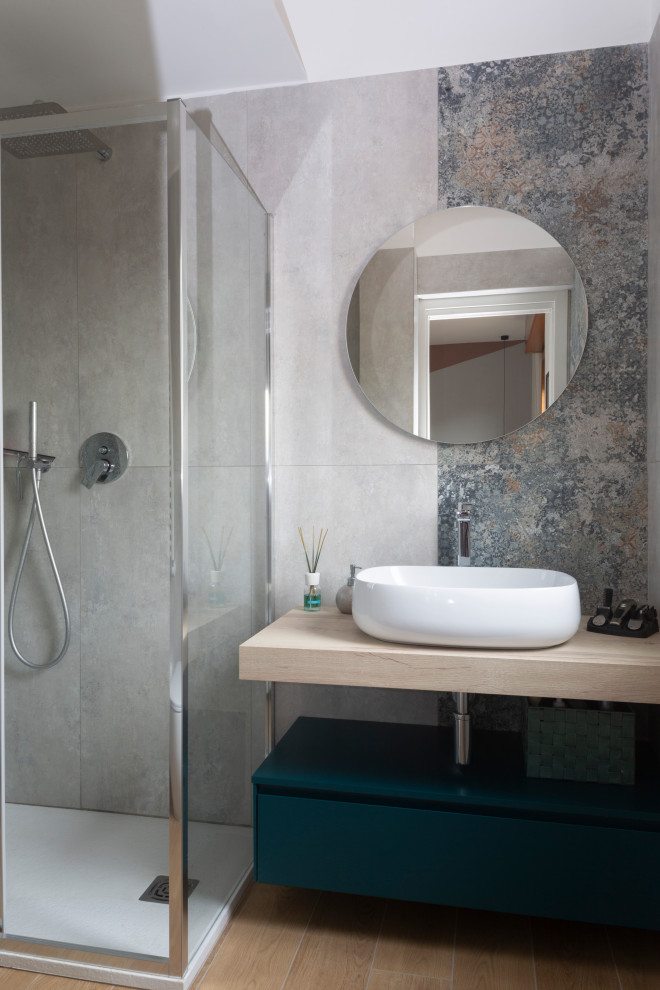 ローマにある高級な小さなモダンスタイルのおしゃれなバスルーム (浴槽なし) (青いキャビネット、コーナー設置型シャワー、木製洗面台、引戸のシャワー、洗面台1つ、独立型洗面台) の写真
