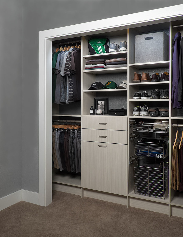 Photo of a small transitional men's built-in wardrobe in Phoenix with flat-panel cabinets, carpet and grey cabinets.