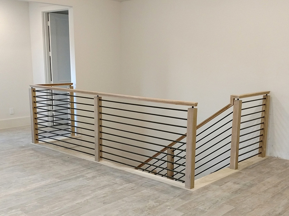 This is an example of a mid-sized modern staircase in Houston.