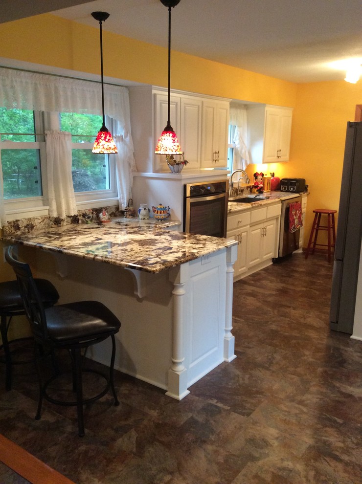 Huge kitchen photo in Minneapolis with an undermount sink and stainless steel appliances