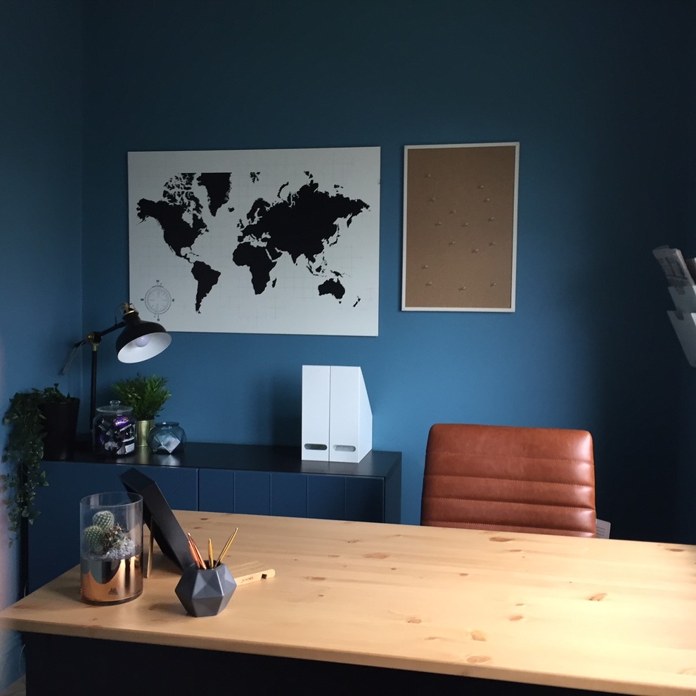 Photo of a small contemporary study room in Other with blue walls, laminate floors, a freestanding desk and yellow floor.