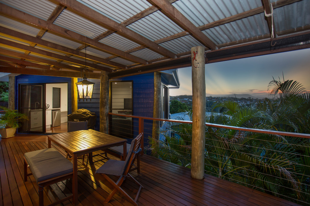 Large tropical backyard deck in Brisbane with a roof extension.