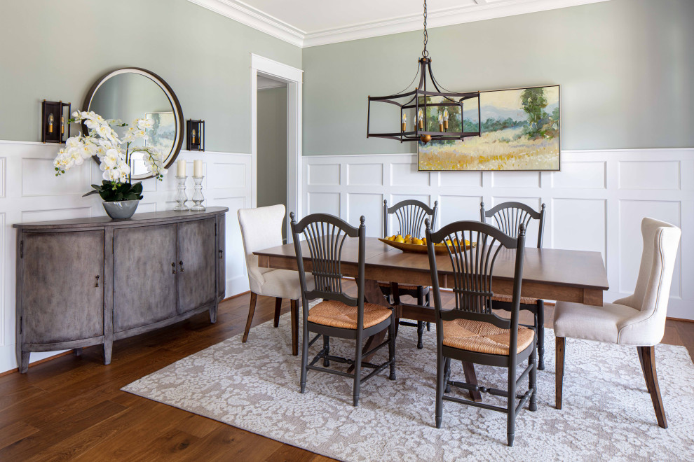 Photo of a mid-sized transitional separate dining room in Richmond with green walls, medium hardwood floors, no fireplace, brown floor and decorative wall panelling.