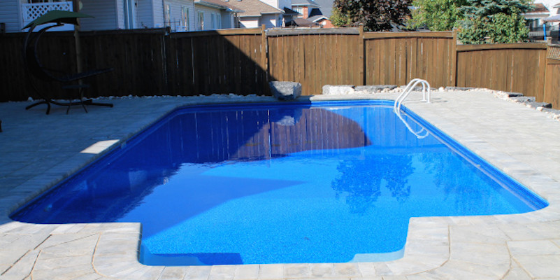 Inspiration for a mid-sized backyard stamped concrete and rectangular pool remodel