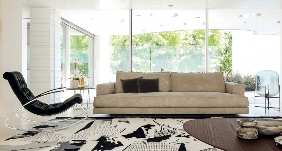 This is an example of a large contemporary open concept living room in Miami with white walls and carpet.