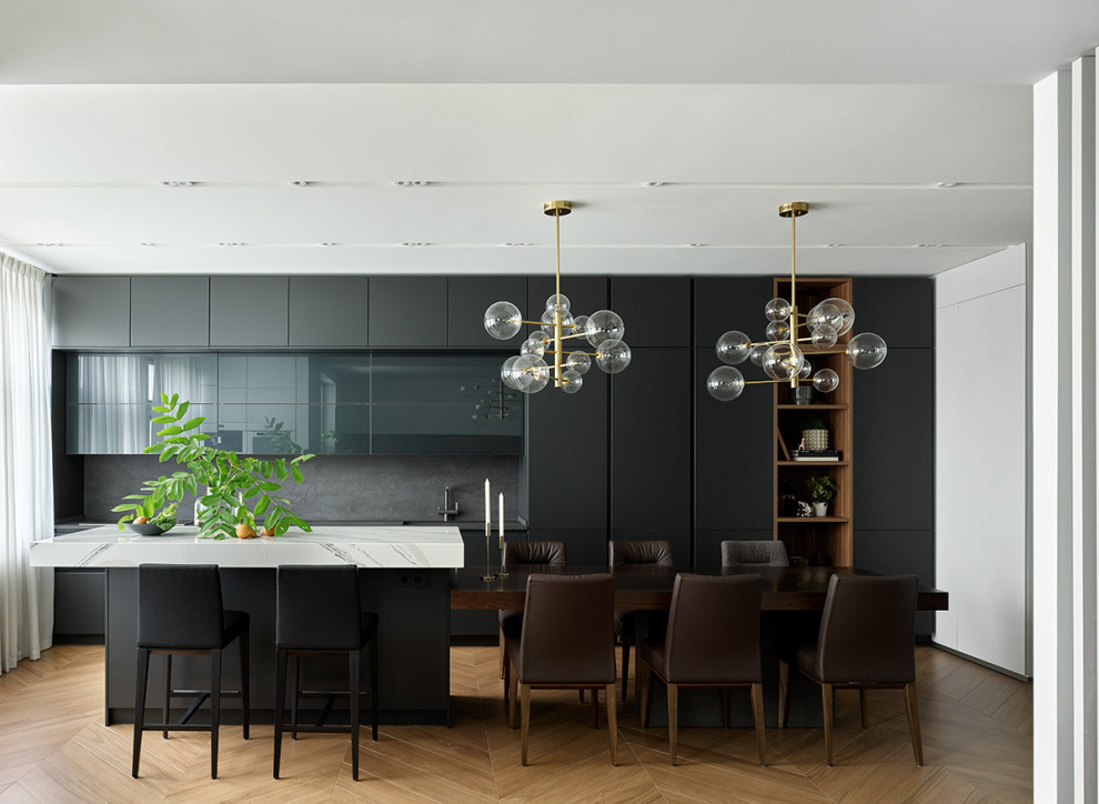 Expansive contemporary single-wall eat-in kitchen in Moscow with an undermount sink, flat-panel cabinets, black cabinets, granite benchtops, black splashback, granite splashback, white appliances, porcelain floors, with island, brown floor, black benchtop and recessed.