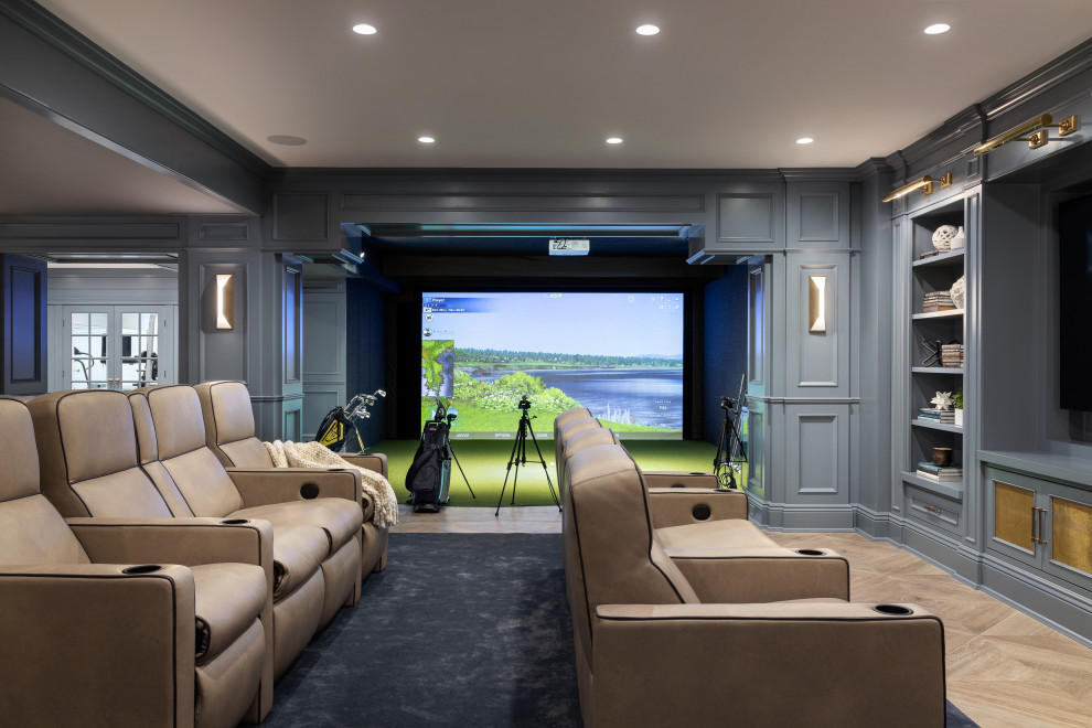 Photo of a mid-sized contemporary enclosed home theatre in New York with multi-coloured walls, medium hardwood floors and a built-in media wall.