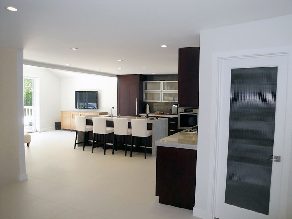 This is an example of a contemporary l-shaped eat-in kitchen in Sacramento with a single-bowl sink, flat-panel cabinets, dark wood cabinets, marble benchtops, stainless steel appliances, ceramic floors and with island.