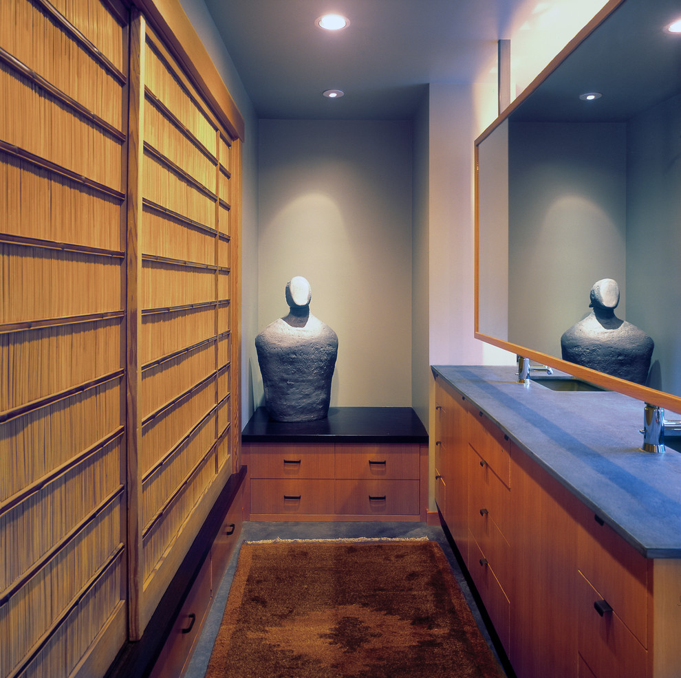 Mid-sized contemporary gender-neutral dressing room in Portland with flat-panel cabinets and medium wood cabinets.