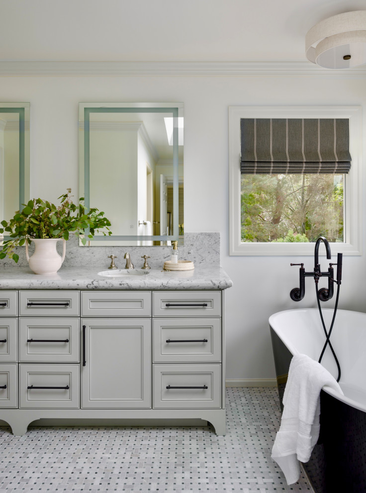 This is an example of a transitional bathroom in Seattle with recessed-panel cabinets, grey cabinets, a freestanding tub, white walls, mosaic tile floors, an undermount sink, grey floor, grey benchtops, a double vanity and a built-in vanity.