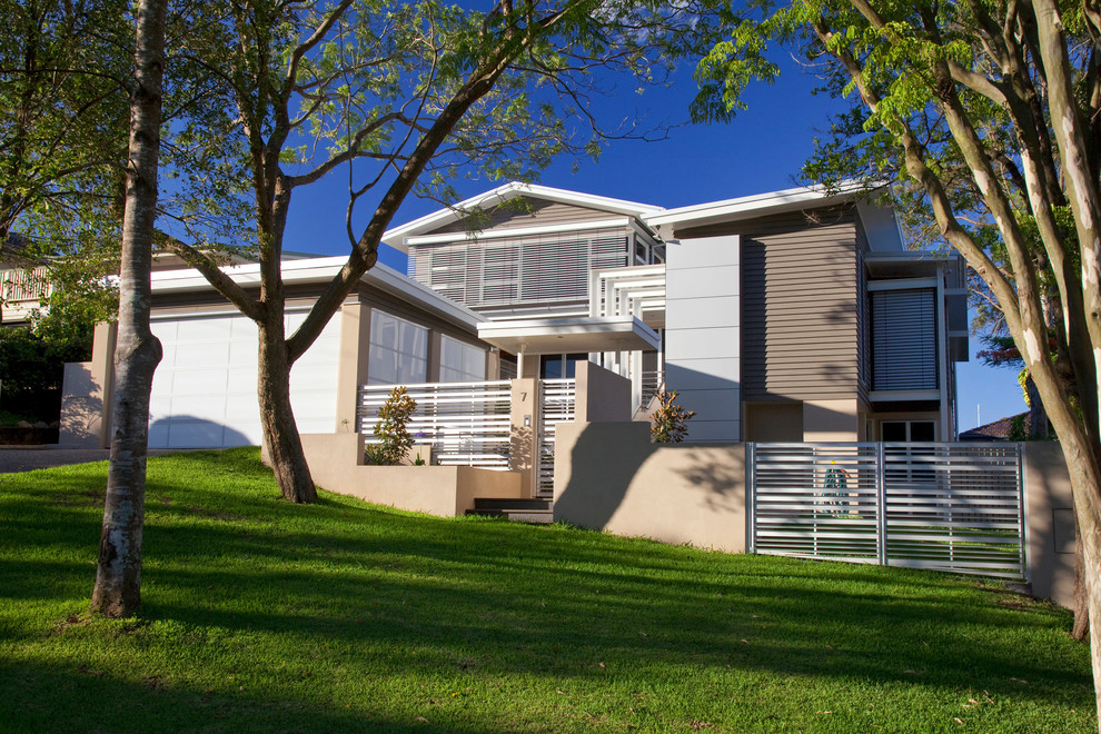 Design ideas for an expansive contemporary three-storey multi-coloured house exterior in Brisbane with a metal roof.