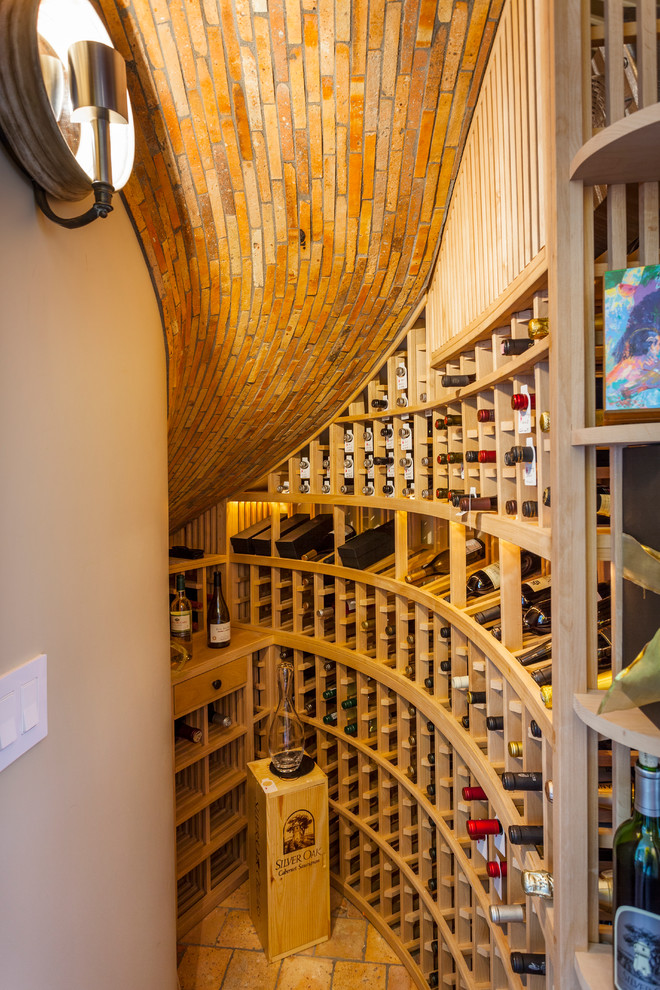 This is an example of a beach style wine cellar in Orange County.