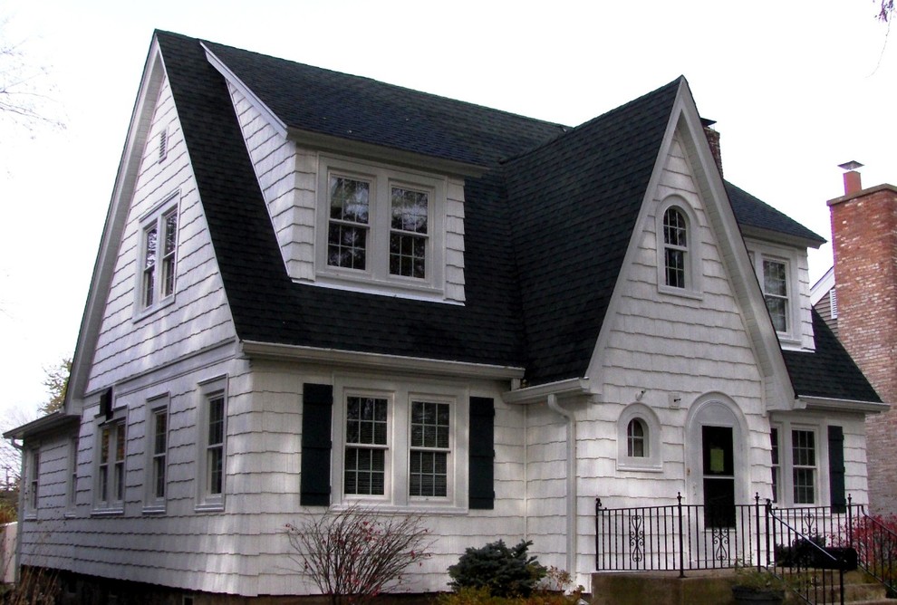Photo of a mid-sized traditional two-storey white house exterior in Chicago with wood siding, a gable roof and a shingle roof.