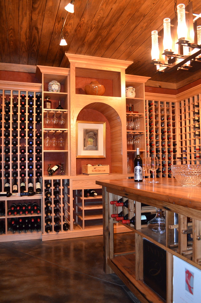 Design ideas for a large traditional wine cellar in Charlotte with concrete floors and storage racks.
