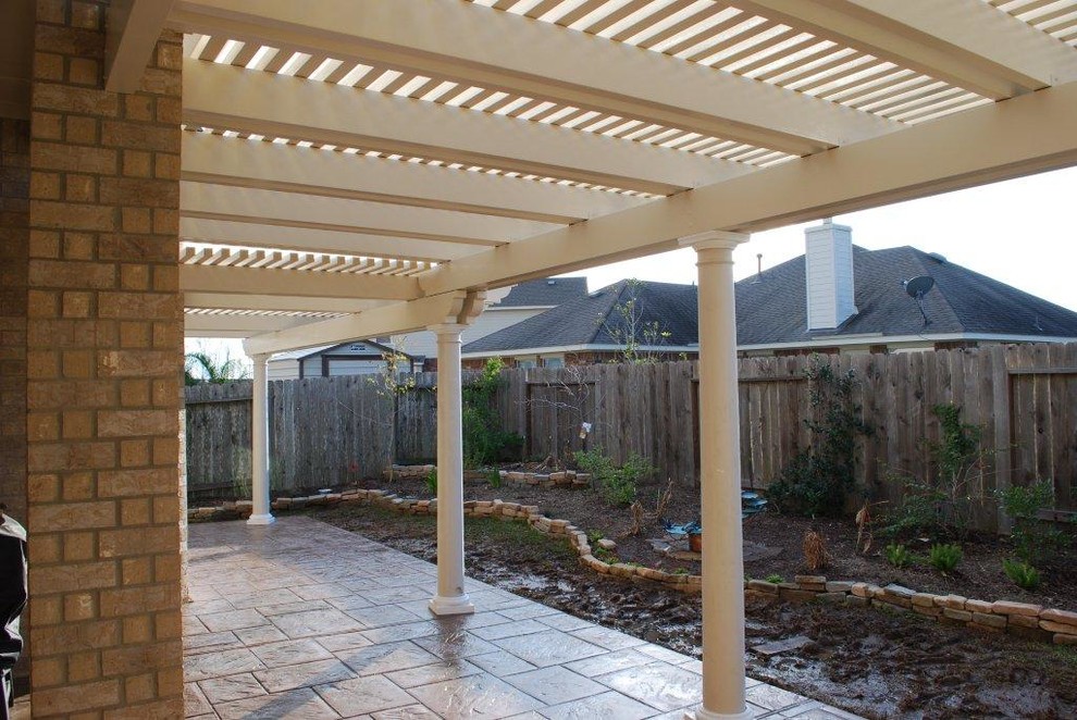 This is an example of a small backyard patio in Houston with a pergola.