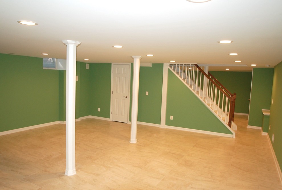 Photo of a mid-sized traditional fully buried basement in Newark with green walls, porcelain floors, no fireplace and beige floor.