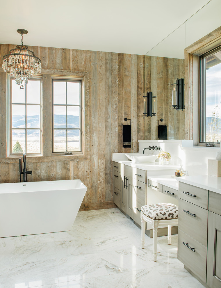 Country master bathroom in Other with grey cabinets, a freestanding tub, a vessel sink and white floor.