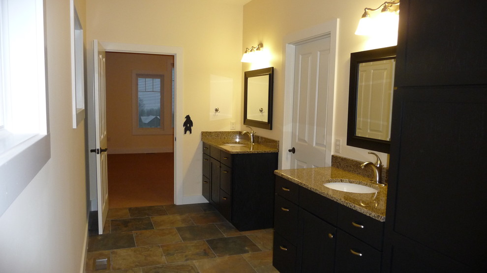 Transitional master multicolored tile and ceramic tile ceramic tile drop-in bathtub photo with flat-panel cabinets, dark wood cabinets, a two-piece toilet, white walls, an undermount sink and granite countertops