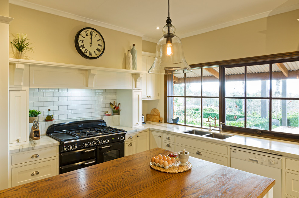 Design ideas for a traditional kitchen in Melbourne with an undermount sink, shaker cabinets, white cabinets, subway tile splashback and slate floors.