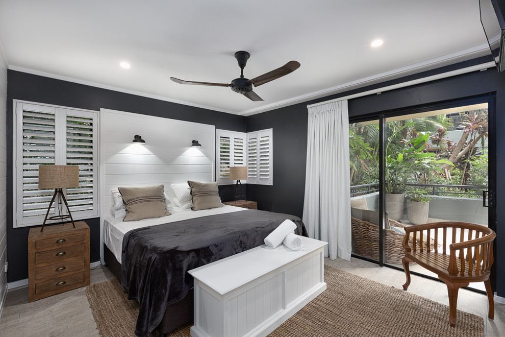 Beach style bedroom in Sunshine Coast with blue walls and grey floor.