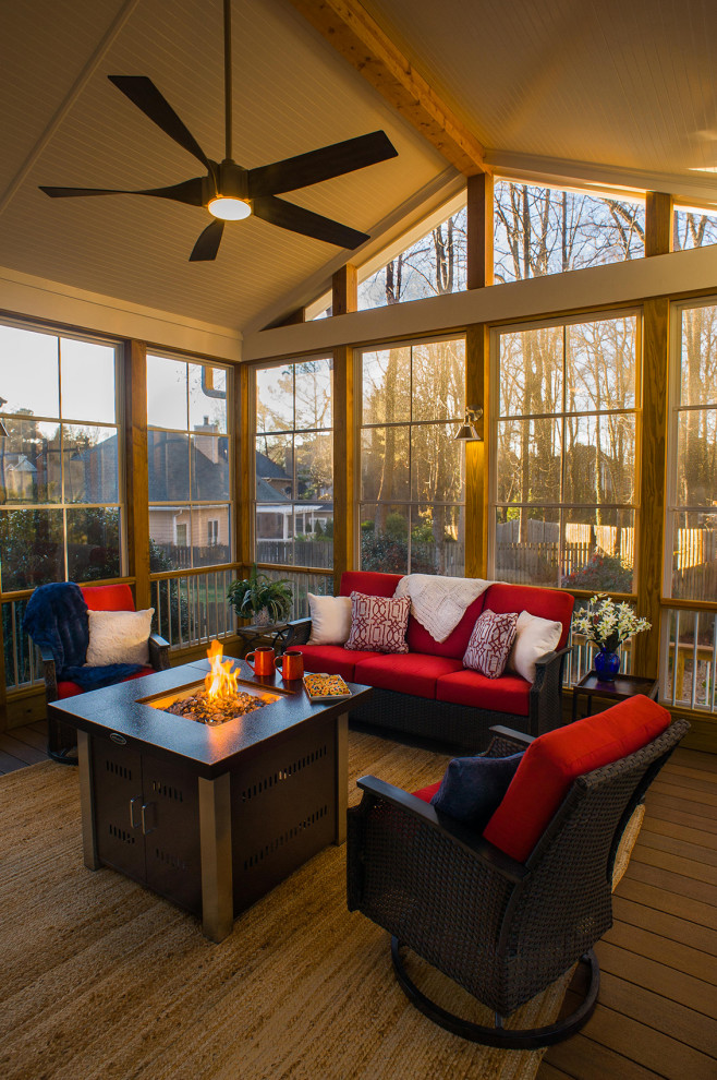 Transitional wood railing back porch idea in Atlanta with a fire pit and a roof extension